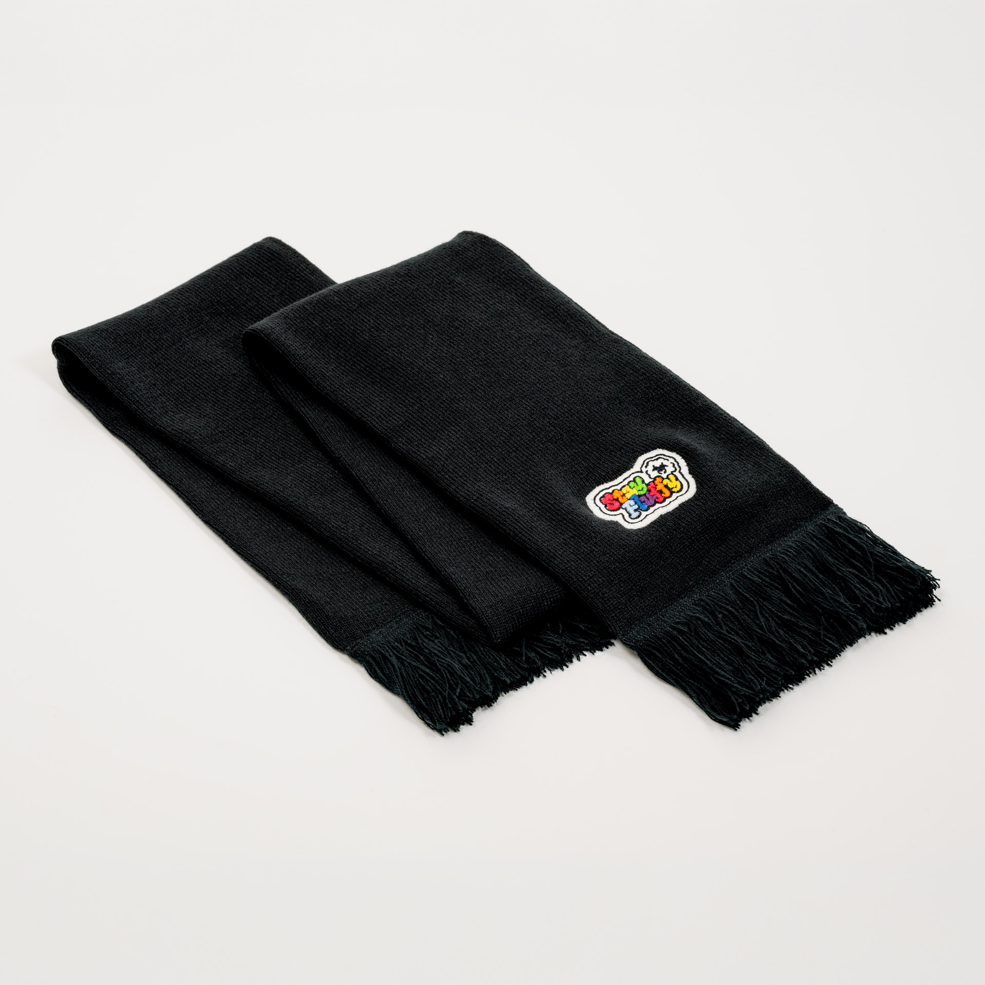 Full view of the folded limited edition scarf "stay fluffy" on a white background