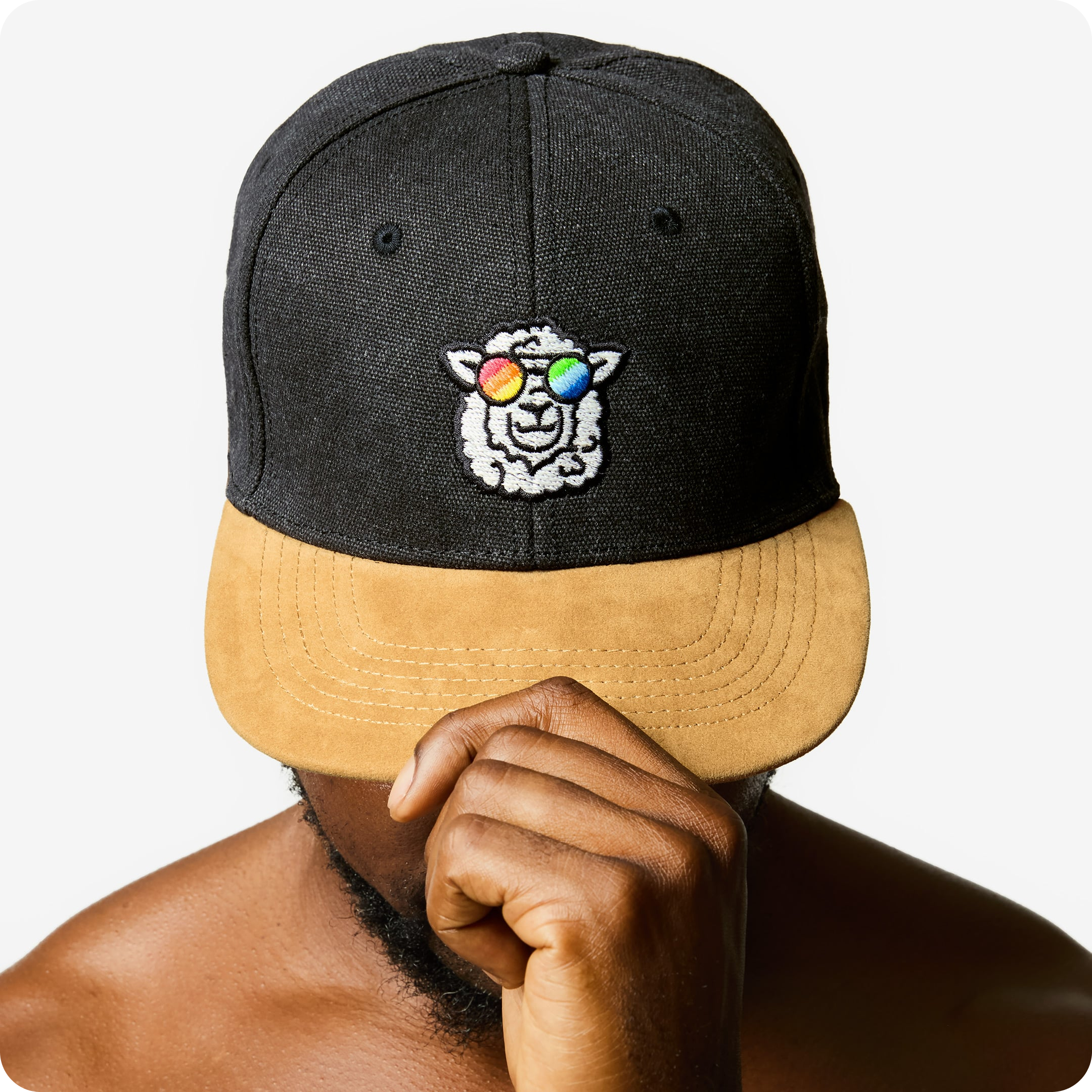 "Sunny" Skater Cap by Rainbow Wool "Sunny" Skater Cap with a sheep motif made of gay sheep wool on a male model’s head.