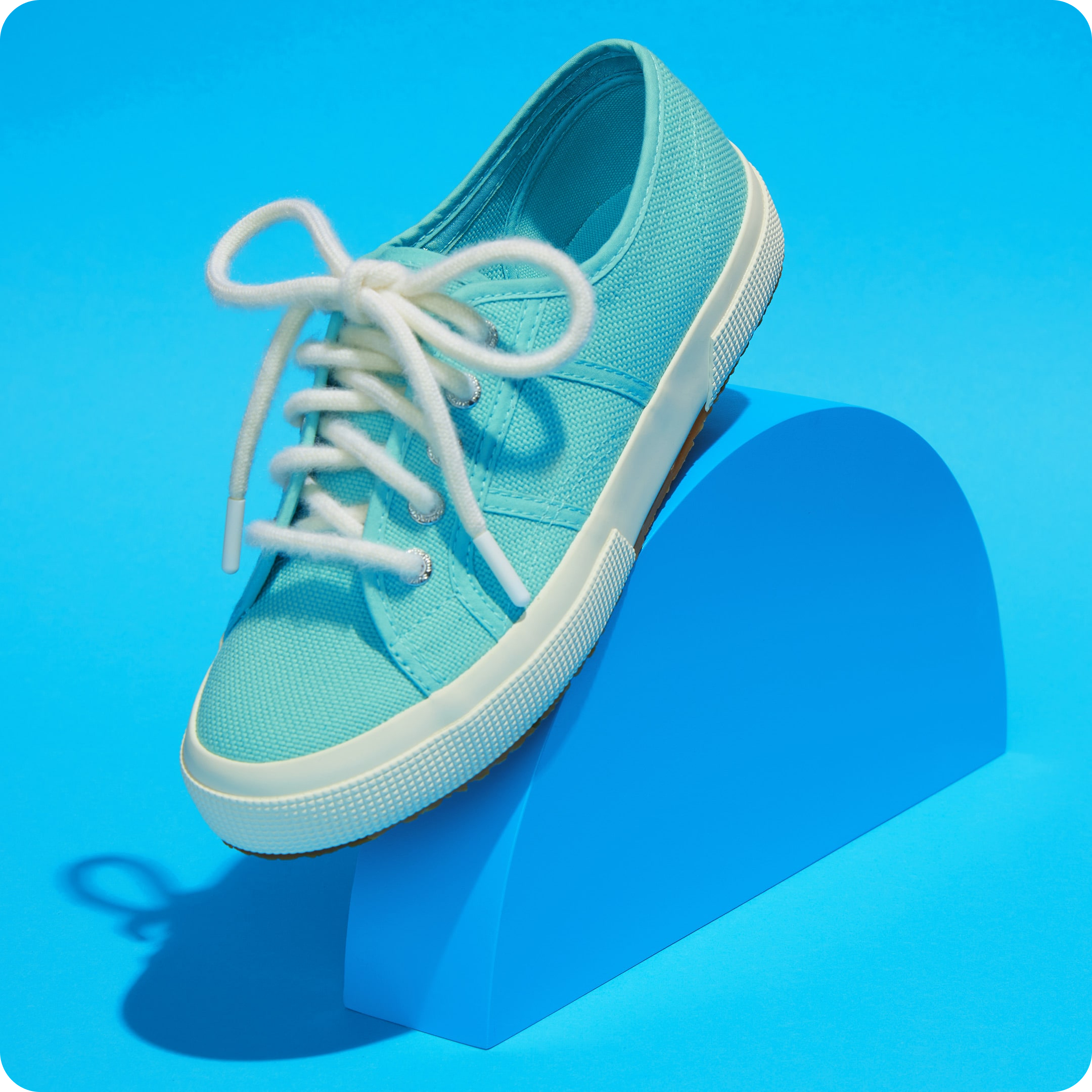 Rainbow Wool Laces by Rainbow Wool Rainbow Wool Laces made of gay sheep wool on a colorful sneaker in front of a colorful background.