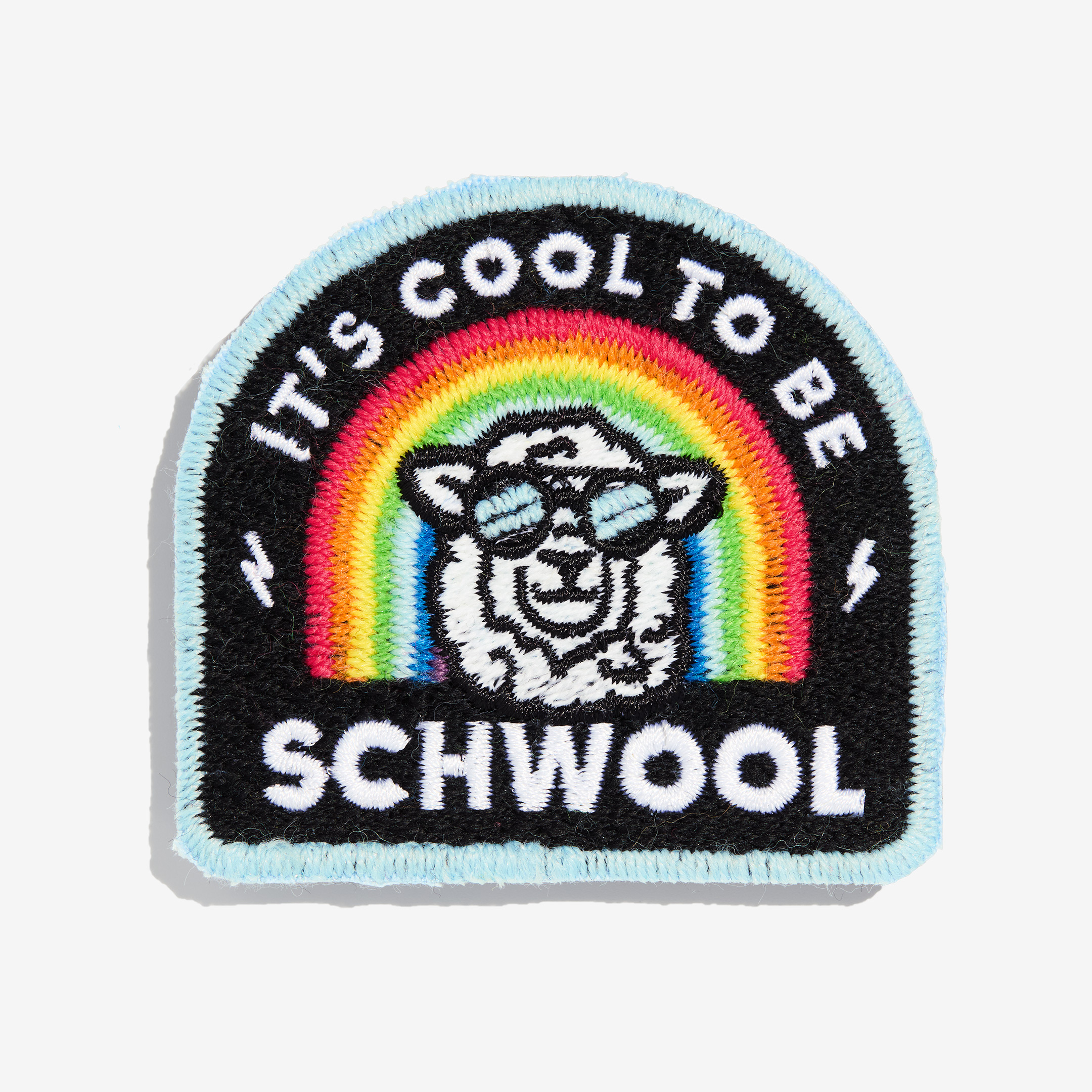 Patch "It's cool to be schwool" made of gay sheep wool on a white background.