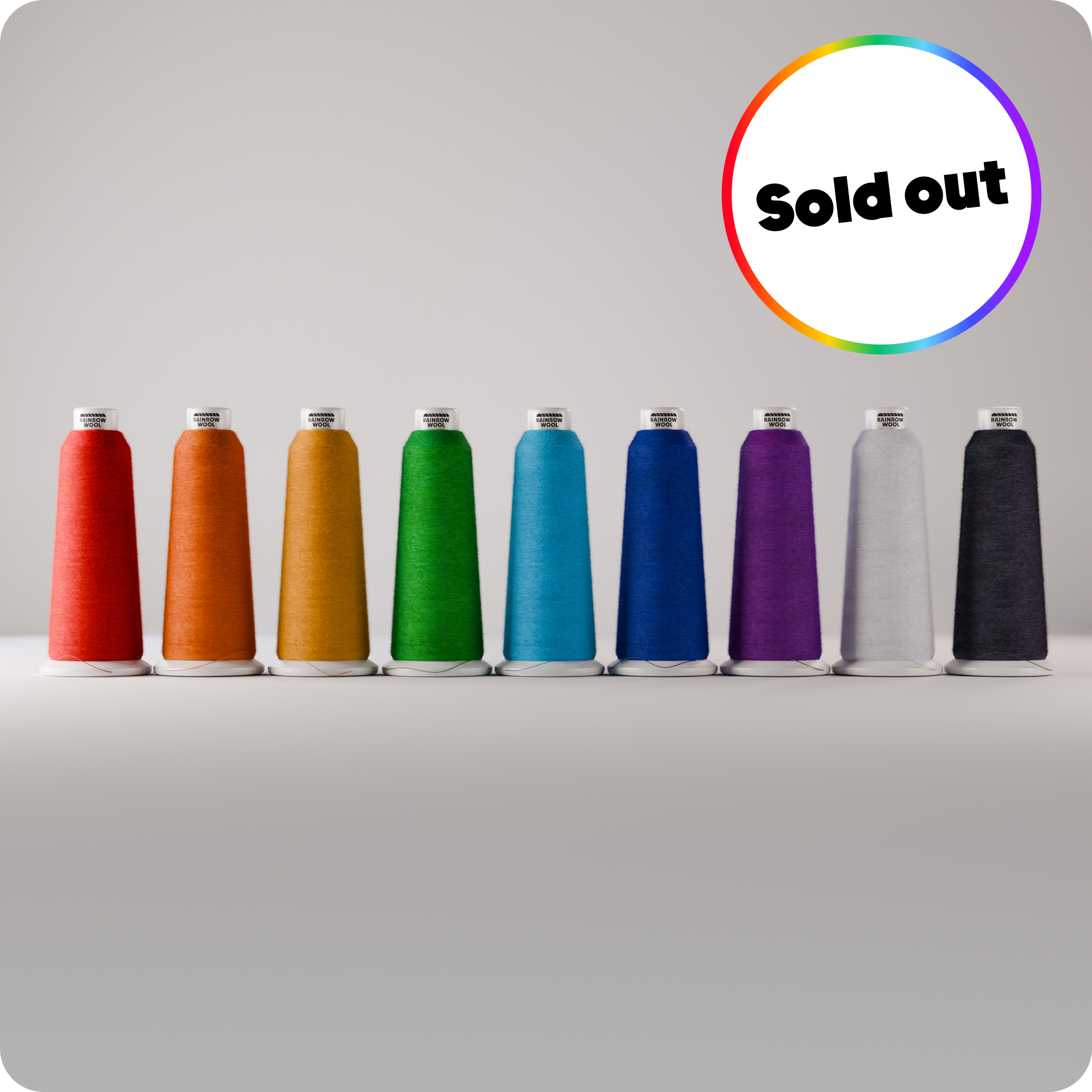 Colour Range of Rainbow Wool Bobbins in front of a grey background. A little text says: sold out