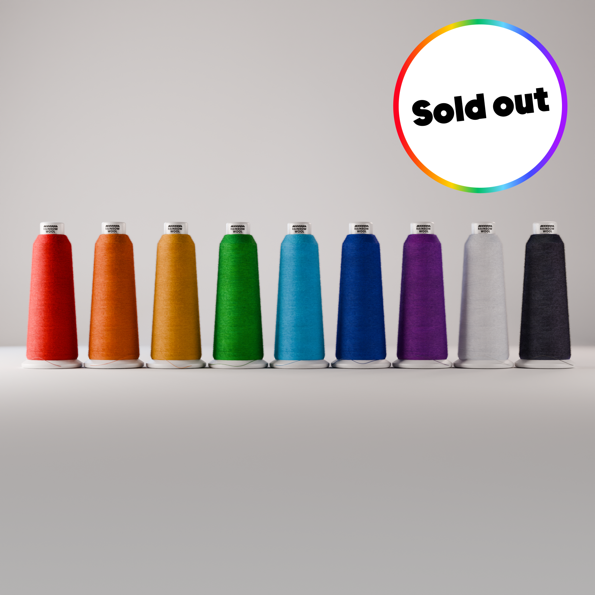 Colour Range of Rainbow Wool Bobbins in front of a grey background. A little text says: sold out