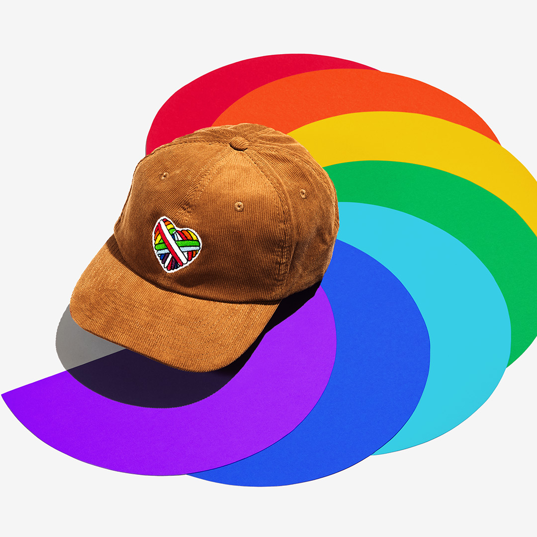 "Woolen Heart" Corduroy Cap with a heart motif made of gay sheep wool on a colorful background.