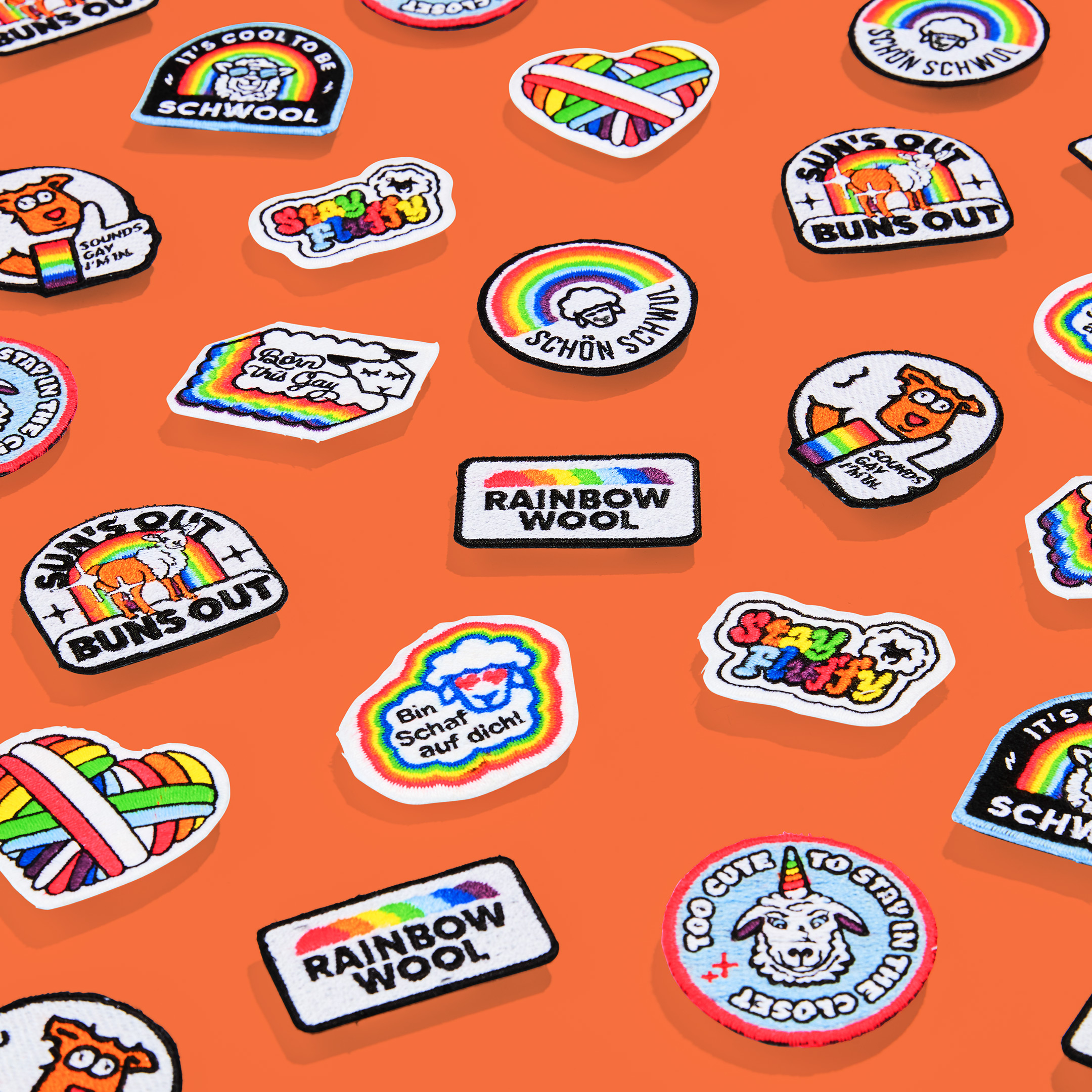 All colorful Rainbow Wool Patches made from gay sheep wool with funny texts on an orange background