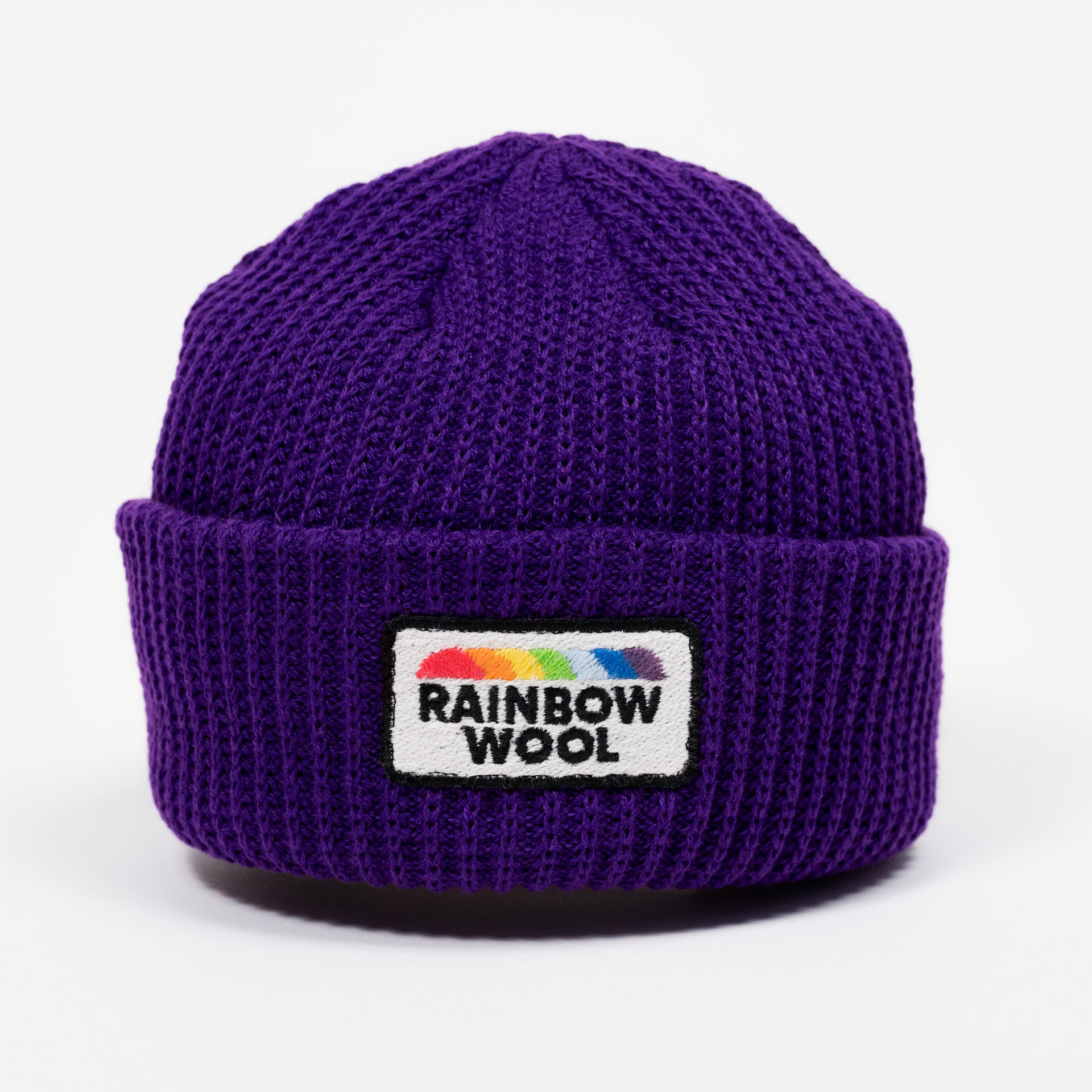 Front view of the limited edition beanie "Rainbow Wool" on a white background 