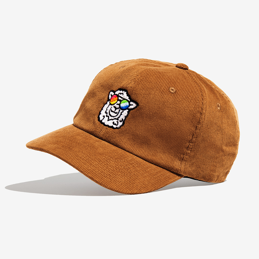 "Sunny" Corduroy Cap with a sheep motif made of gay sheep wool on a white background.