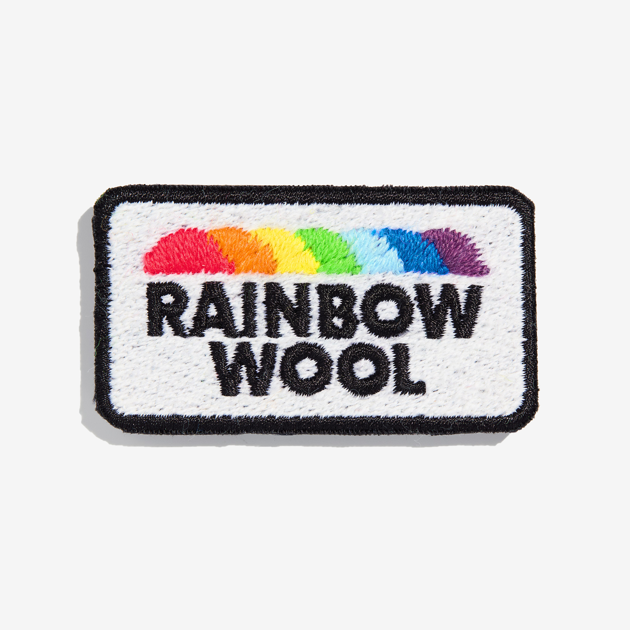 Patch "Rainbow Wool" aus schwuler Schafwolle auf einem weißen Hintergrund.