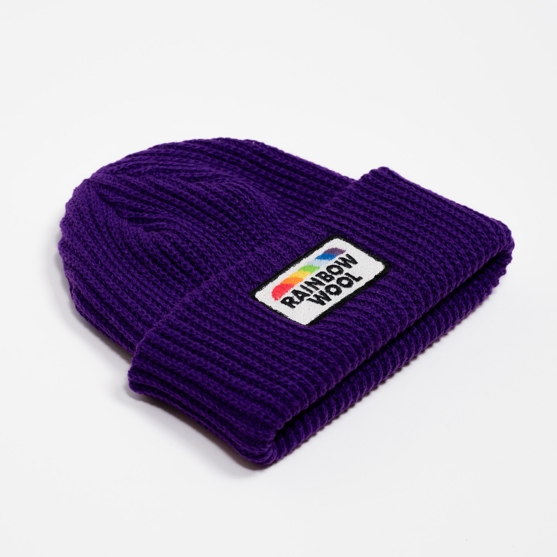 Quarter view of the limited edition beanie "Rainbow Wool" on a white background 